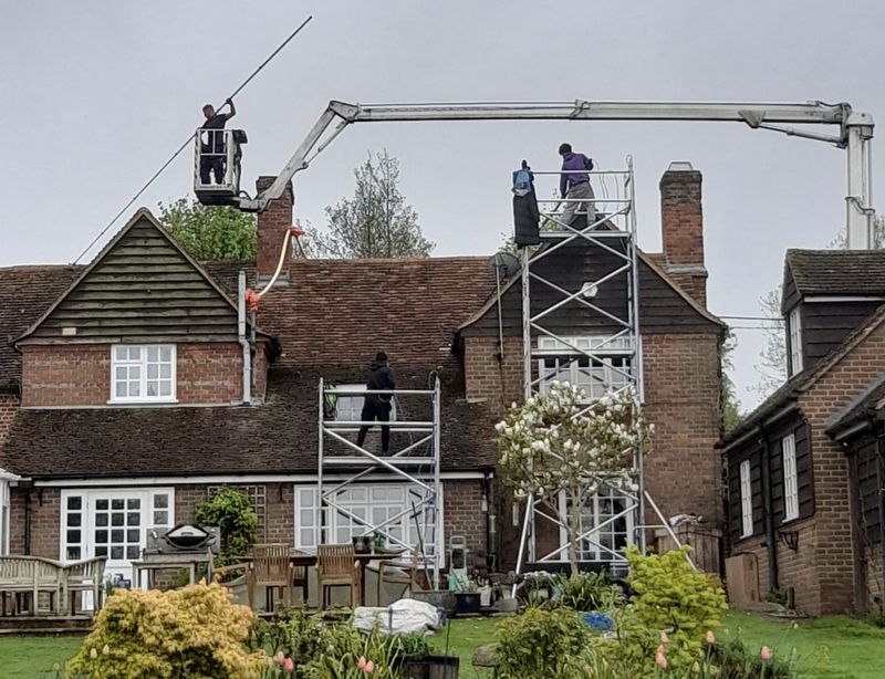 The Moss Cleaners using cherry picker and scaffolding to clean roof safely and professionally in Shoreham-by-Sea, West Sussex